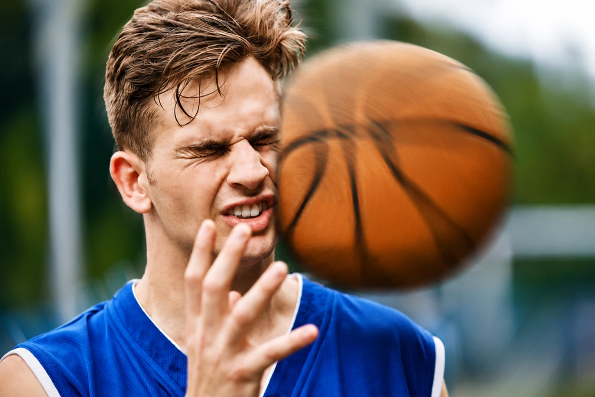 Basketball striking a player's face causing a potential sports eye injury